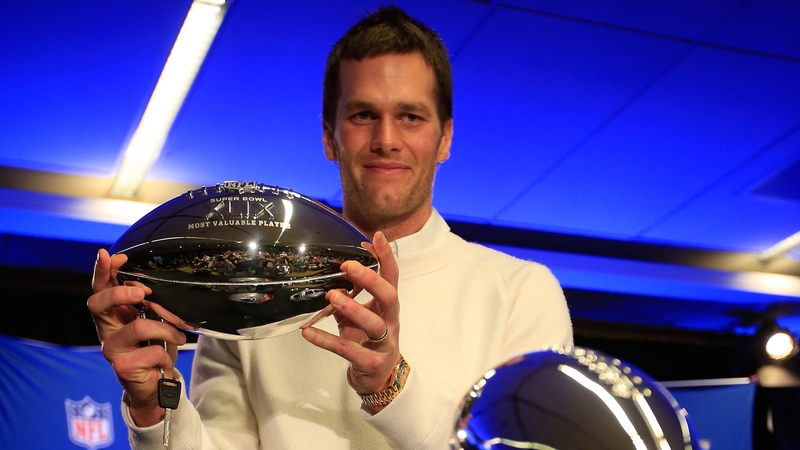 Tom Brady holds the Super Bowl XLIX MVP trophy