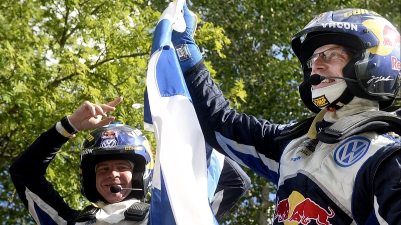 Jari-Matti Latvala (R) and co-pilot Miikka Anttila celebrate with the Finnish flag on the top of their car
