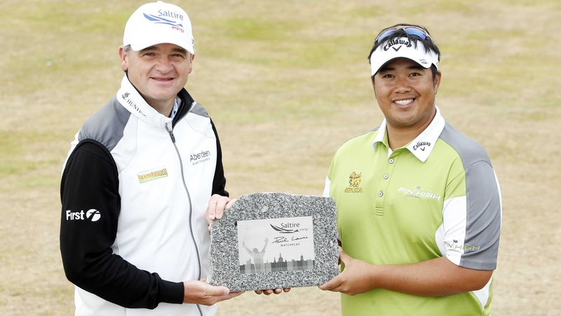 Tournament host Paul Lawrie presents Kiradech Aphibarnrat with his trophy for winning in Aberdeen