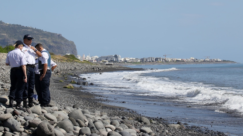 Police search a beach on Reunion where debris has washed up