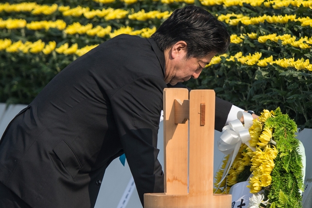 Japanese Prime Minister Shinzo Abe lays a wreath