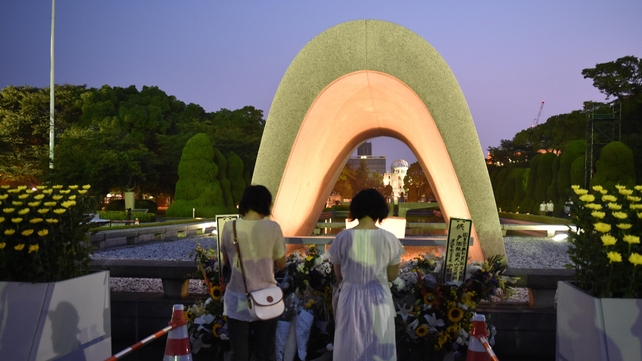 Women pray for the victims of the 1945 atomic bombing, at the Peace Memorial Park in Hiroshima