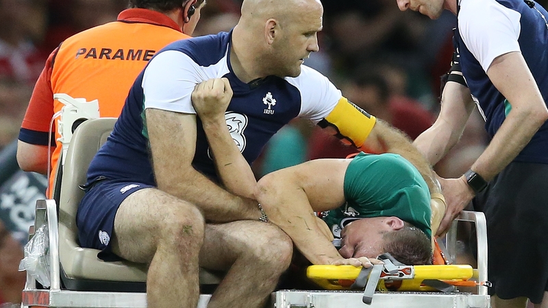 Tommy O'Donnell leaves the field under the care of Ireland team doctor Éanna Falvey
