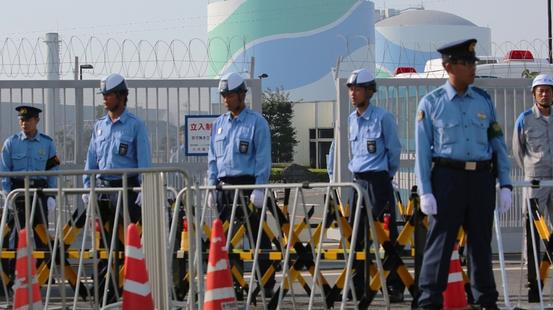 Police officers and security personnel at the Sendai nuclear power plant