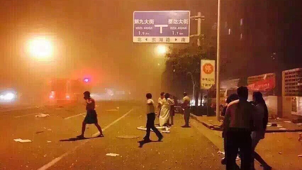 People on a street after the explosion in Tianjin