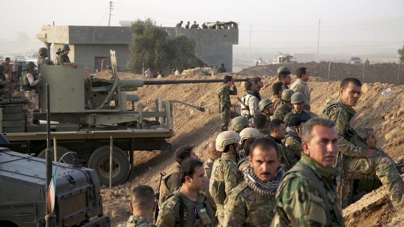 Kurdish soldiers take up positions, south of Kirkuk in northern Iraq