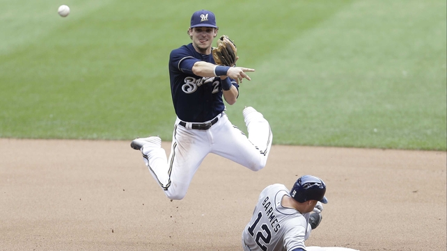 Scooter Gennett of the Milwaukee Brewers attempts a double play at Miller Park in Wisconsin