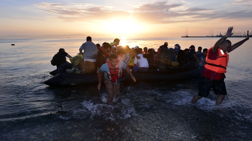 A dinghy with Syrian refugees arrives at a beach on Kos after crossing the Aegean sea from Turkey to Greece