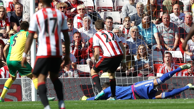 Norwich City's Russell Martin (L) scores