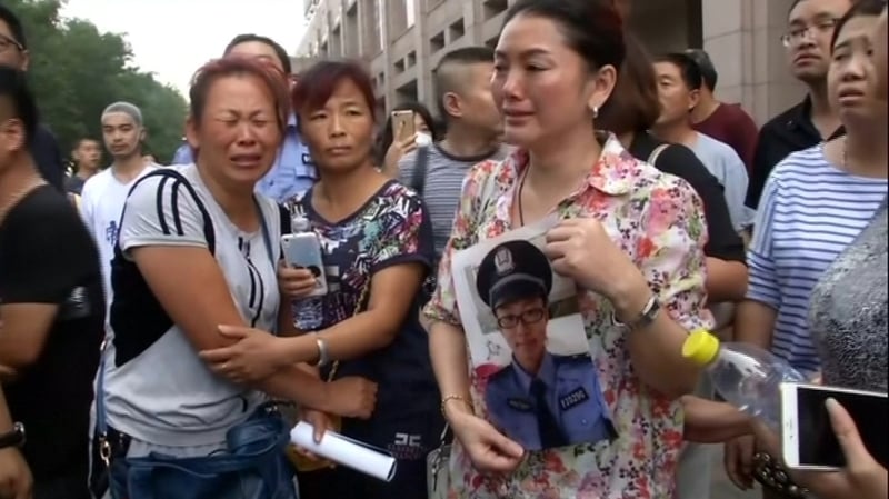 Family members of firefighters still missing after two blasts ripped through Tianjin attempted to protest outside the local city hall