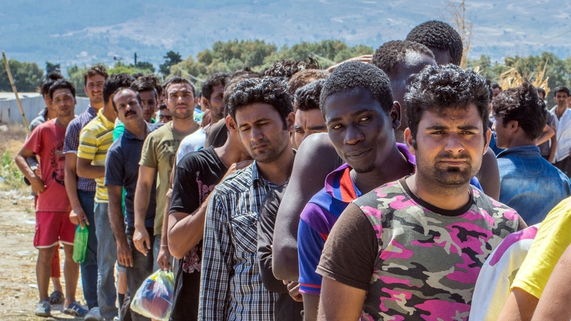 Migrants queue for donated supplies in Kos