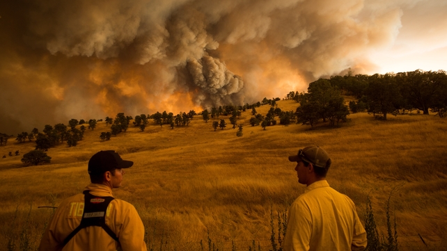 Firefighters watch as a wildfire burns near Clearlake, California