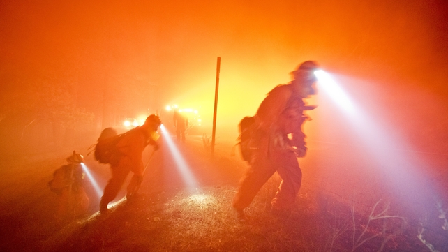 A fire crew hikes to a paved road outside of Wrightwood, California