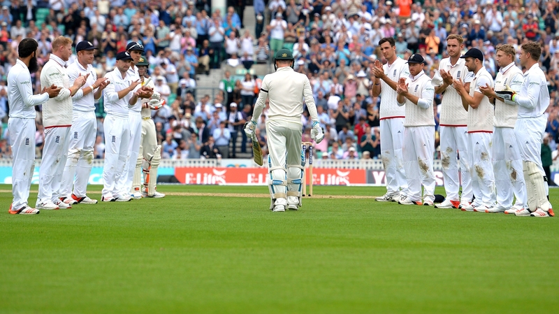 The England team applaud Australia's retiring captain Michael Clarke as he walks to the wicket in his final Test match