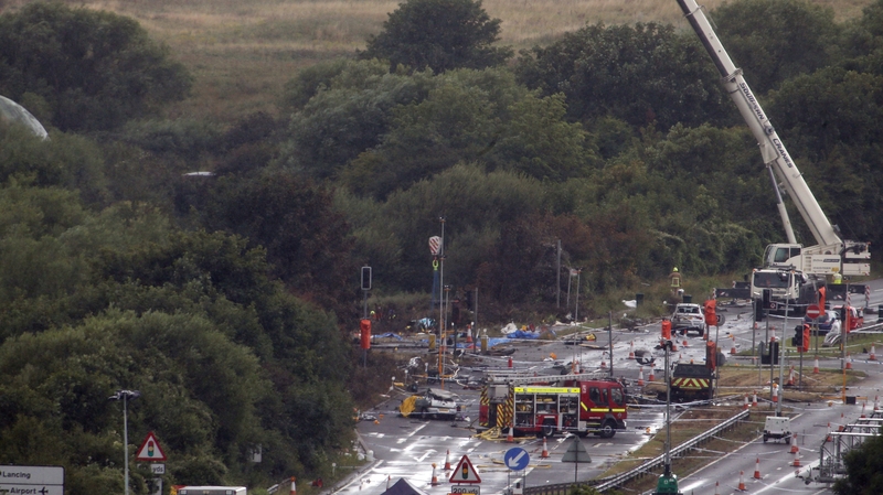 Part of the aircraft's wreckage is removed by crane