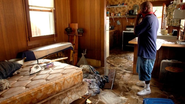 Duane Bush, who stayed in his house until the water was chest high and eventually waded through water neck high to escape, looking over the inside of his house after making the first trip back since the water went down in New Orleans