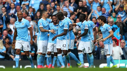 Raheem Sterling is mobbed following his first competitive goal for City