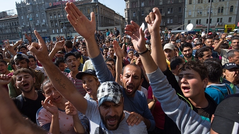 Migrants protest outside a railway station in central Budapest