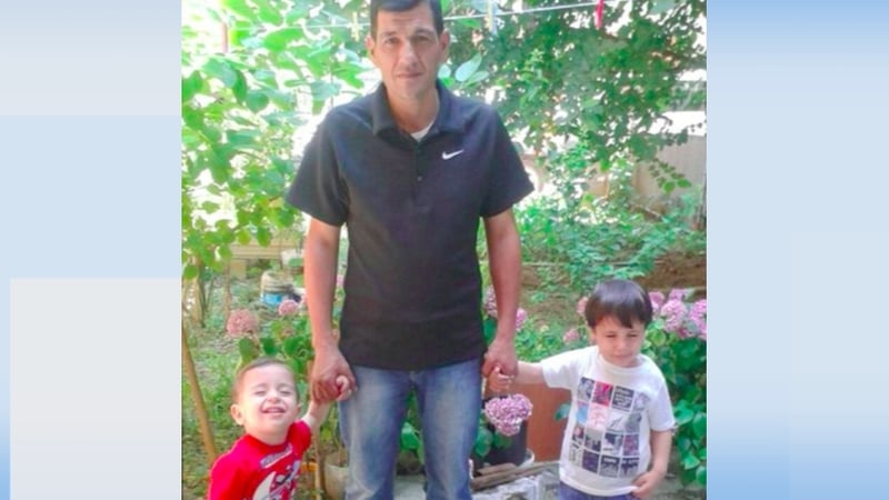 Aylan Al-Kurdi (L) and his brother Galip (R) with their father Abdullah (C)