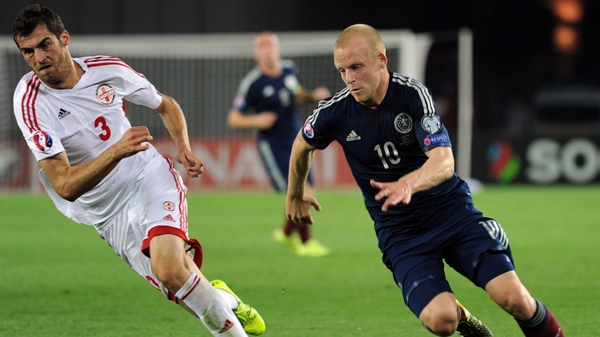 Steven Naismith of Scotland vies for the ball with Georgia's Solomon Kverkvelia