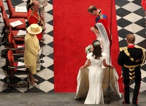 Prince William and his new bride Kate Middleton bow to the queen at their wedding in April 2011