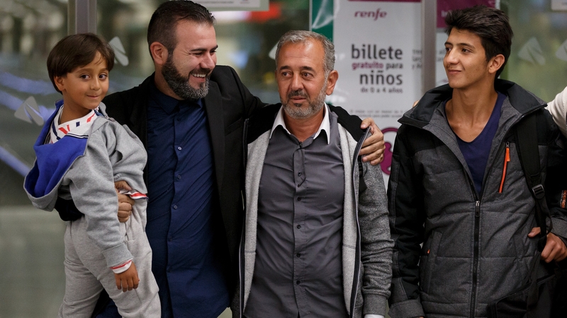 Osama Abdul Mohsen (2R), is pictured with his sons Mohamed, 18, and seven-year-old Zaid along with Miguel Angel Galan on their arrival in Madrid
