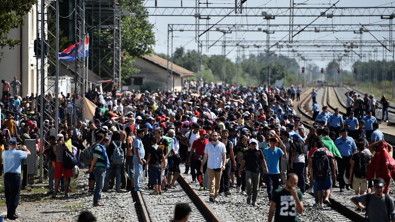 People wait at Tovarnik station in Croatia for a train to Zagreb