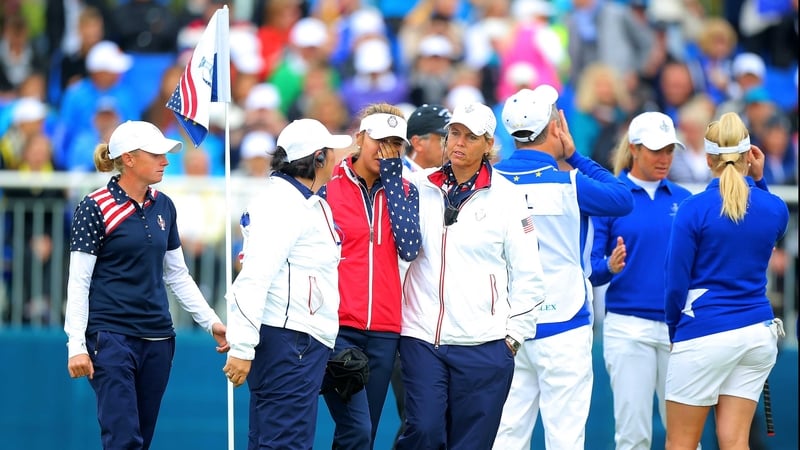 Alison Lee is comforted by US assistant captains Nancy Lopez and Wendy Ward on the 18th green after her error in picking up her ball on the 17th hole before it had been conceded by her European opponents Suzann Pettersen and Charley Hull