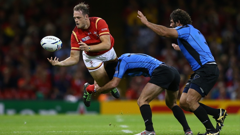 Cory Allen of Wales is tackled by Uruguay's Rodrigo Silva