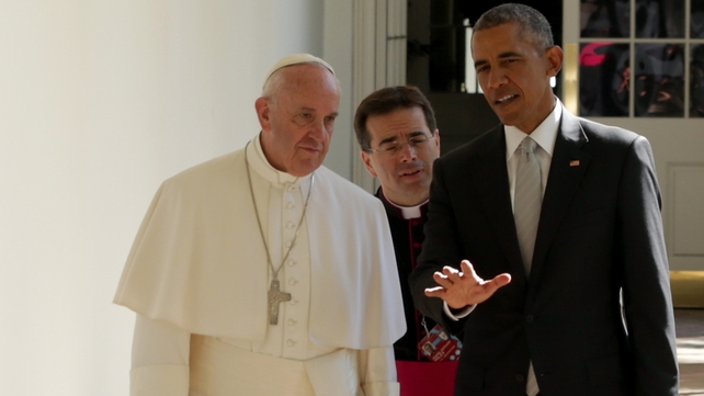 The Pope and President Obama in discussion as they walk in the grounds of the White House
