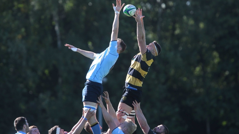 UCD's Emmet MacMahon competes with Michael Madden of Young Munster