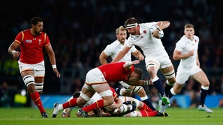 Tom Wood of England attempts to beat the tackle of Dan Lydiate of Wales