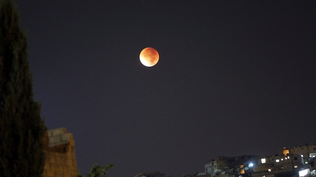 The supermoon and a total lunar eclipse is seen over Damascus, Syria