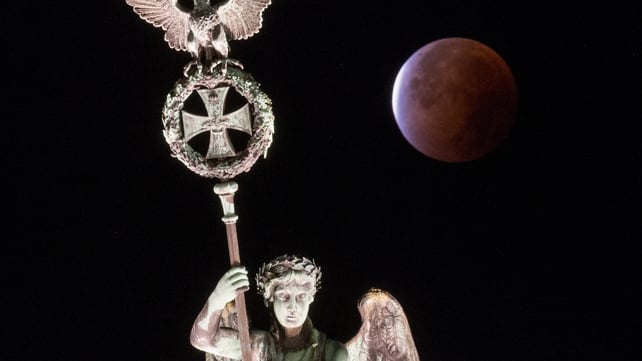 The supermoon during a lunar eclipse above the Brandenburg Gate in Berlin, Germany,