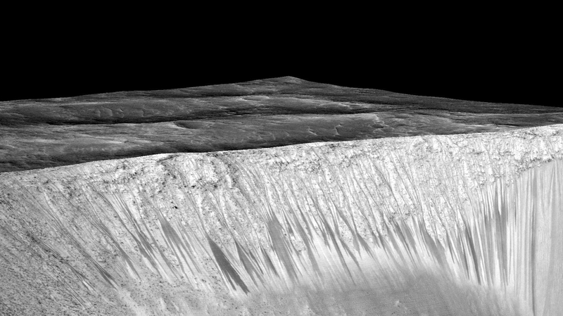 US researchers said long gullies running down slopes on Mars were caused by flowing water