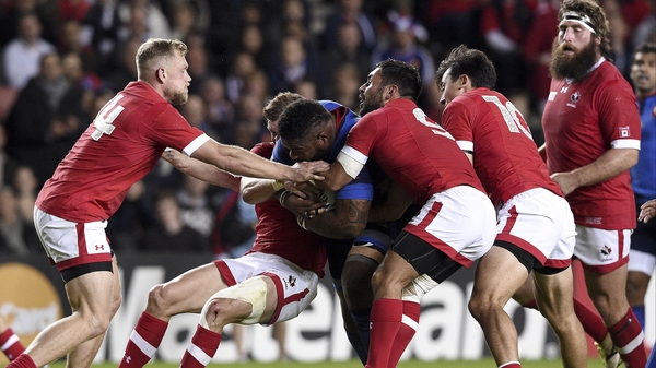 France's centre Mathieu Bastareaud (C) is tackled by four Canadian players
