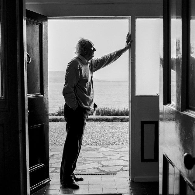 Friel leans on the front door of his home