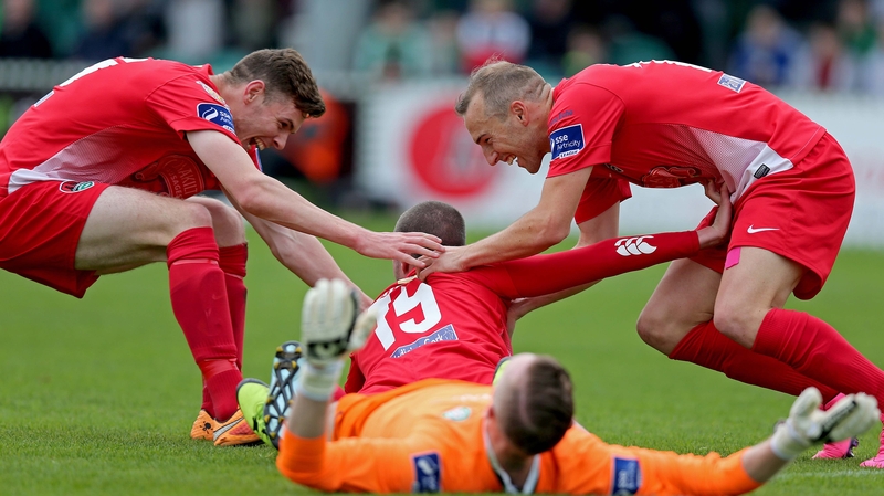 Kael Sheppard and Garry Buckley congratulate Cork goalscorer Danny Morrissey