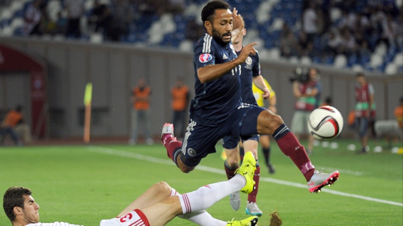 Ikechi Anya (R) of Scotland in action against Georgia