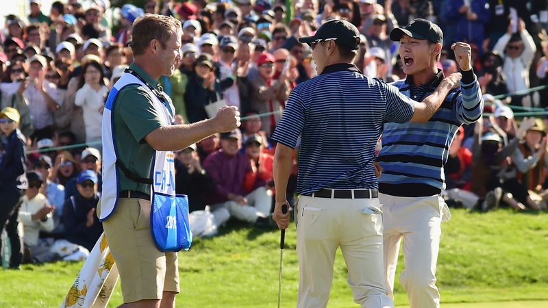 Danny Lee and Sang-Moon Bae celebrate a putt to win with caddie Kurt Kowaluk during today's four-ball matches