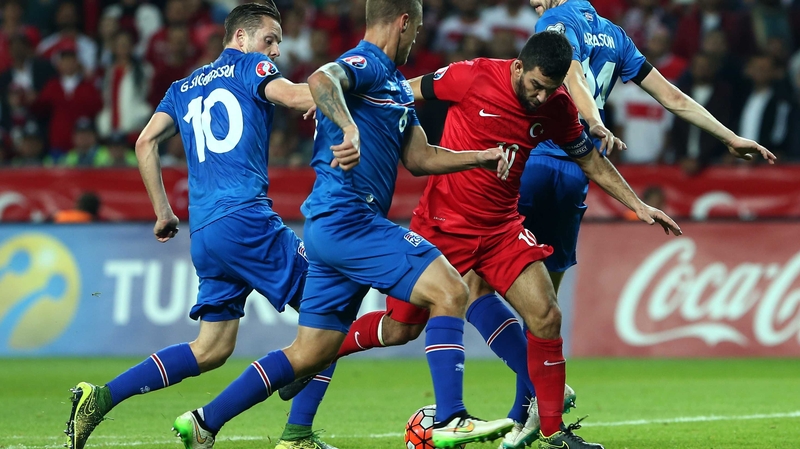 Turkey's Arda Turan vies with Iceland's Gylfy Sigurdsson (left) and Ragnar Sigurdsson (2nd left)