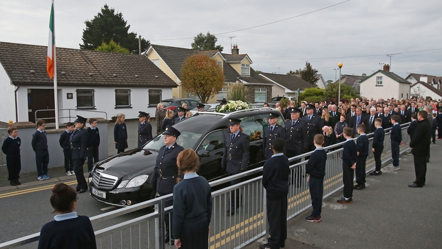 Schoolchildren line the route