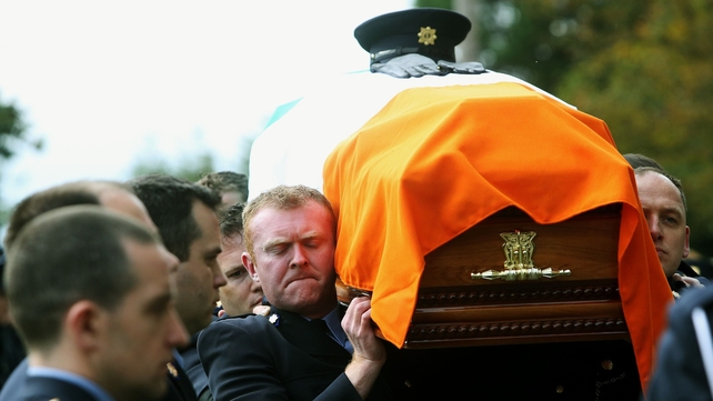 The coffin is carried into the church