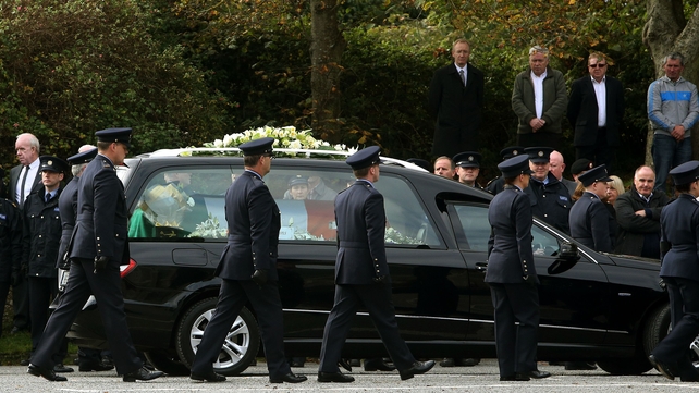 The funeral cortege arrives at the church