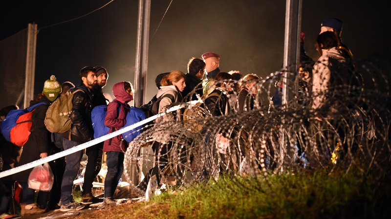 Migrants cross the border before Hungarian police and soldiers closed it at midnight