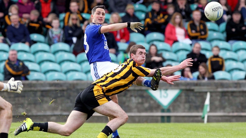 Brendan McDyer gets a shot away despite the efforts of Caolan Ward of St Eunan's