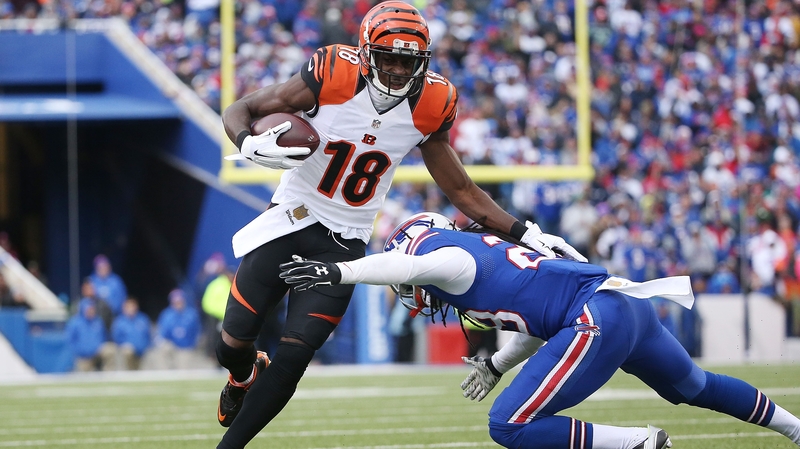 A.J. Green of the Cincinnati Bengals runs after the catch as Corey Graham defends