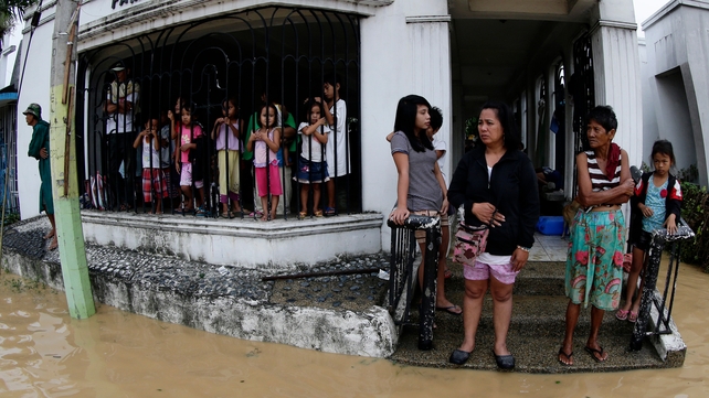 Locals take shelter inside a tomb at a cemetery in Cabanatuan city, northern Manila