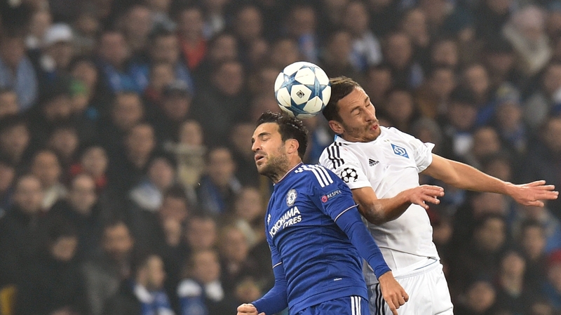 Chelsea's Cesc Fabregas challenges Dynamo Kiev's Ukrainian midfielder Serhiy Rybalka in the air at NSK Olimpiyskyi