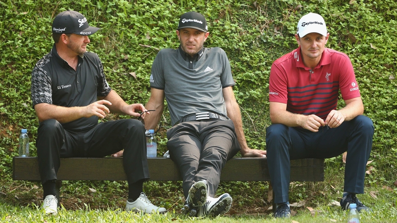 Graeme McDowell, Dustin Johnson and Justin Rose wait for the 5th green to clear